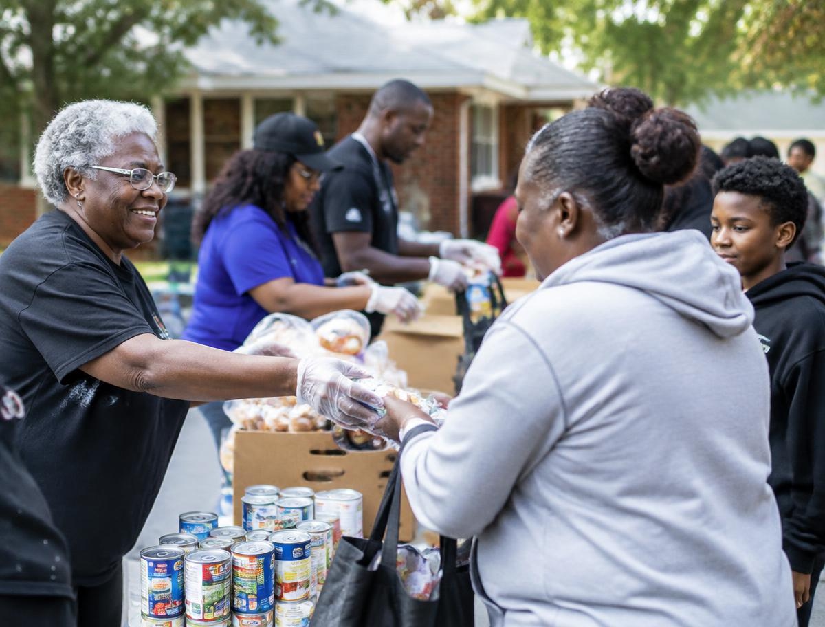 FAC volunteers serving neighbors at a community outreach